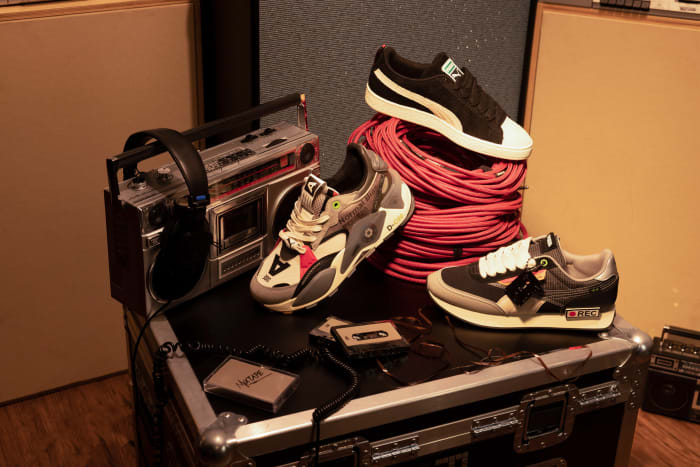 PUMA sneakers propped on a stereo system.
